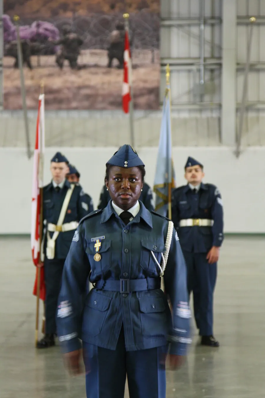 A 12 Edmonton cadet at attention in ceremonial dress in front of the colour party