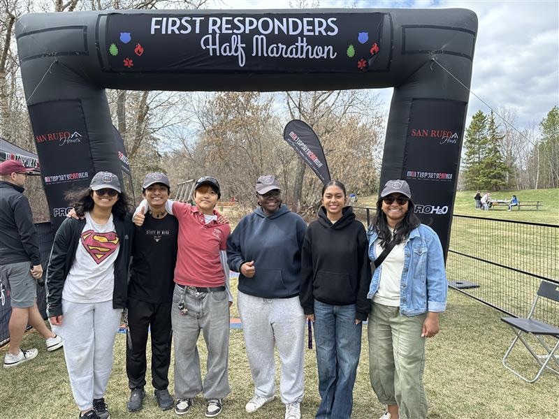 12 Edmonton cadets at the finish-line arch of the Edmonton First Responders Half Marathon